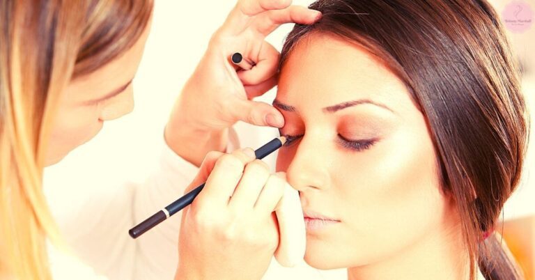 a makeup artist applying eyeliner to a person with olive skin tone for beauty application.
