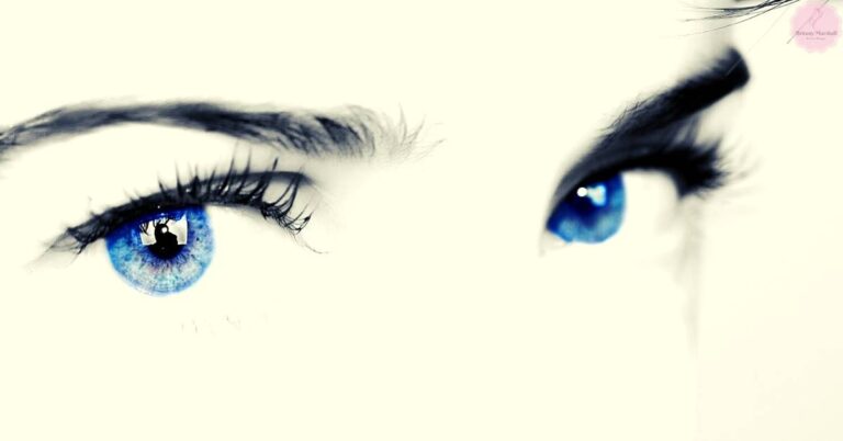 a close-up of two striking blue eyes with long lashes, reflecting light to enhance their natural vibrancy for makeup inspiration.