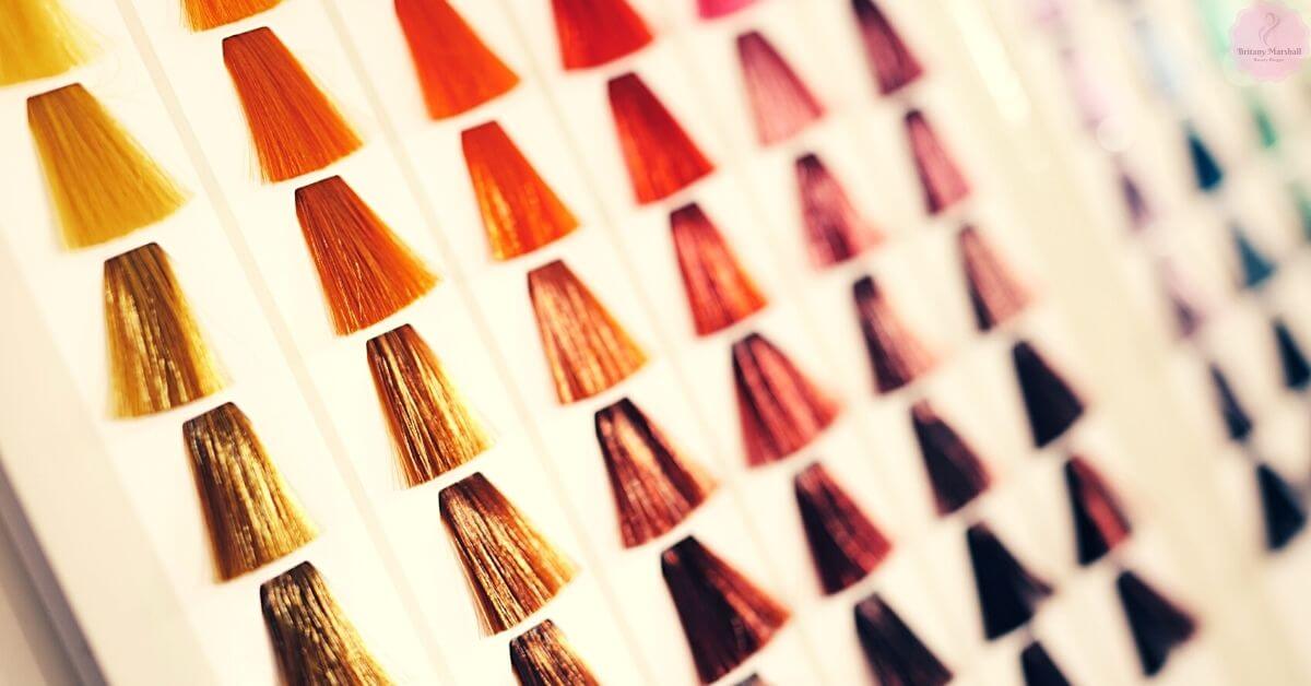 a close-up display of hair color swatches in warm tones, including golden blonde, copper, auburn, and caramel shades, ideal for exploring hair dye options.