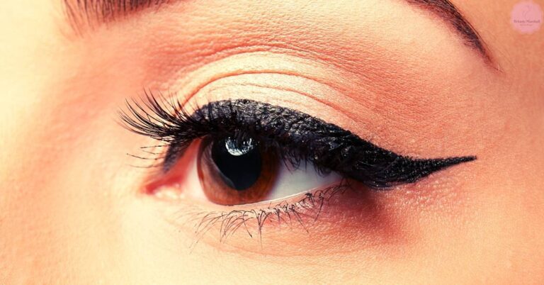a close-up of an eye with bold, dramatic black eyeliner extending into a sharp winged shape for a striking makeup look