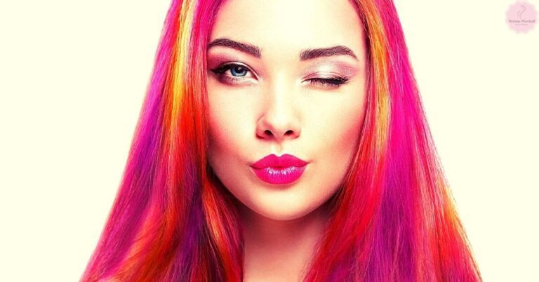 a person with vibrant rainbow-toned long hair showcasing multi-toning effects on bleached strands