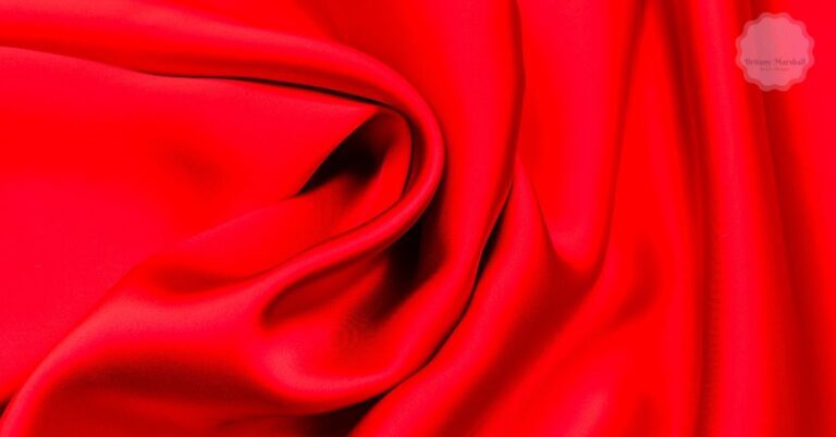 a close-up of vibrant red rayon fabric with a smooth, slightly sheared texture, ideal for sublimation printing.