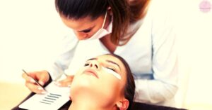 a beauty professional applying precision eyelash extensions to a client’s closed eyes using a fine-tipped tool