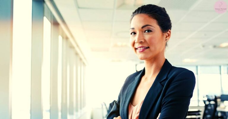 a confident professional in a sleek blazer standing by a modern office window