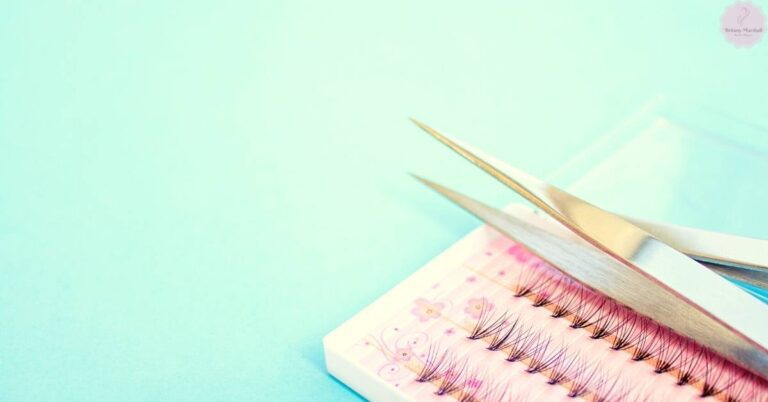 a pair of gold-tipped scissors trimming eyelash extensions on a decorative comb for lash extension correction