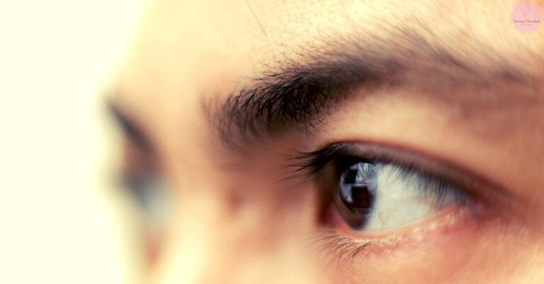 a close-up of a person’s eye with long, dark eyelashes and a slightly upward gaze, highlighting natural lash length variations.
