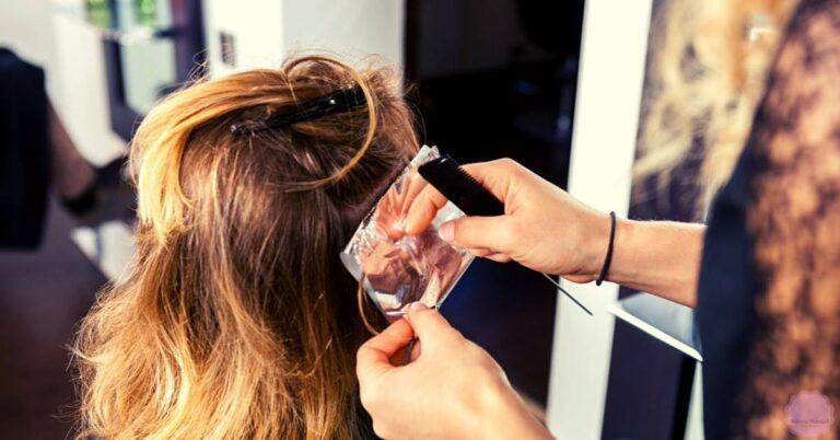 a person receiving a hair lightening treatment with a 20 volume developer application at a salon.
