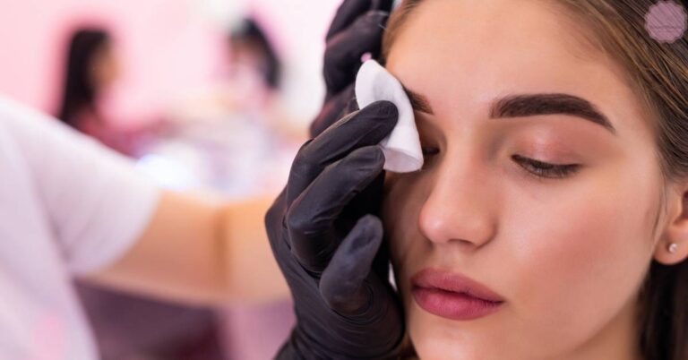 a person receiving a gentle wipe to their eye area after a powder brow application, showcasing smudge-proof makeup technique.