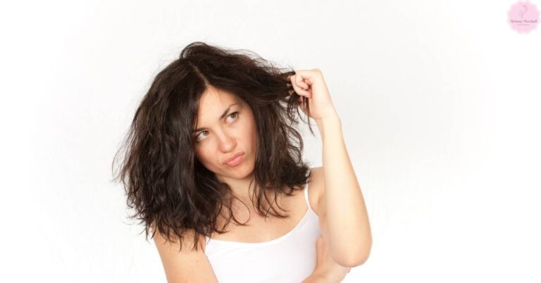 a woman with dry, crunchy hair touching her tangled locks, illustrating hair texture issues after air drying