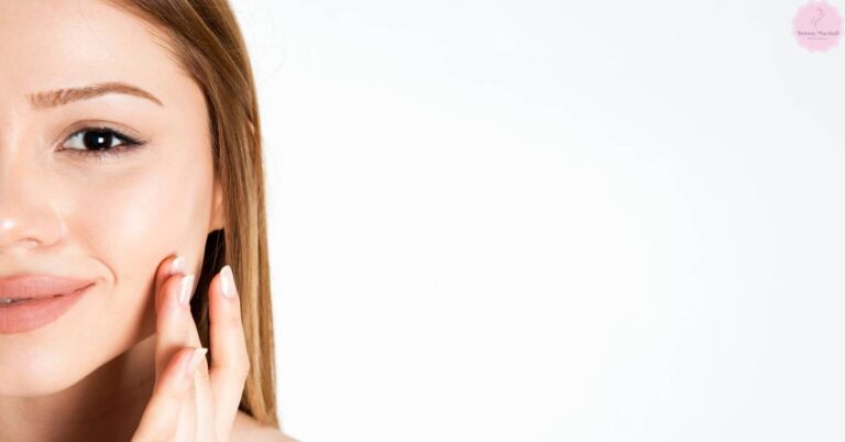 a person applying a skincare product near the cheek, showcasing clear skin care routine.