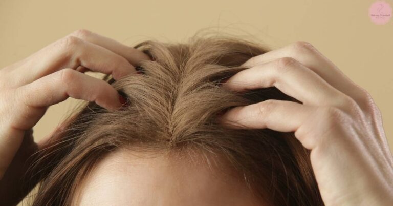 a person gently massaging their scalp to promote hair care and circulation.