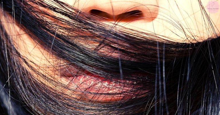 a close-up of hair tangled around a person’s mouth and throat area, illustrating how strands can lodge near the airway.