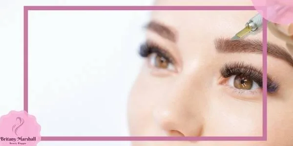 a close-up of a person receiving an eyebrow treatment with a precision tool for natural eyebrow enhancement