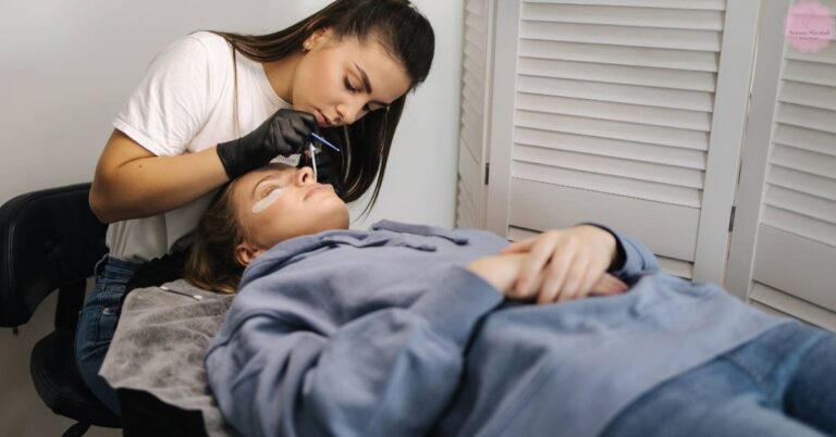 a client receiving precise lash extension application on a comfortable reclined lash bed with proper pillow support