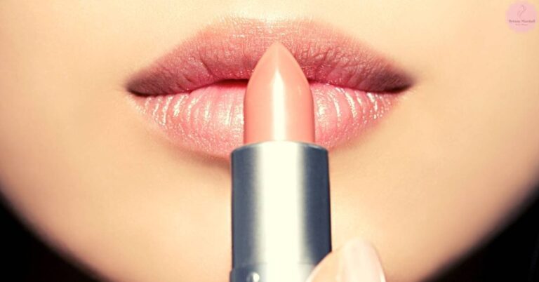 a close-up of lips applying lipstick with a brush applicator during recovery after cosmetic treatment