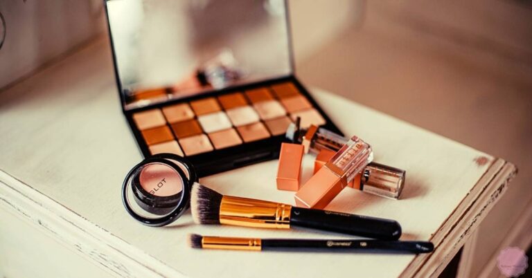 a makeup palette with eyeshadows, blush compacts, lipsticks, and brushes for achieving a natural flawless finish and covering blemishes