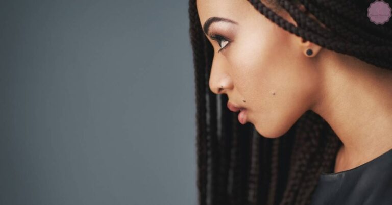 a person with neatly styled side-parted braided hair, showcasing sleek tribal braids for beauty inspiration