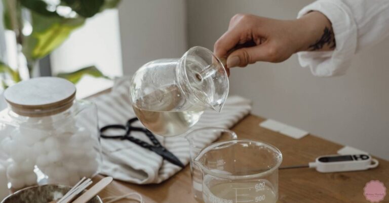 a person pouring liquid wax into a measuring container for candle making, assessing candle wax volume.