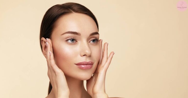 a woman gently lifting her skin under eyes to show smooth, hydrated facial skin with a natural glow