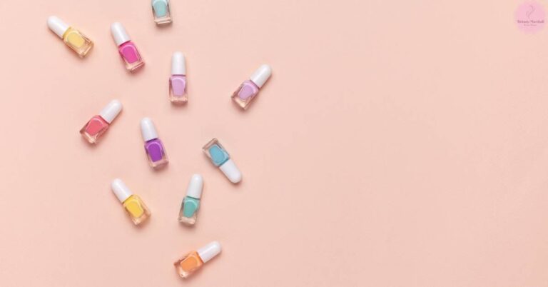 a diverse assortment of nine trendy nail polish bottles in pastel and bright shades arranged on a light peach background