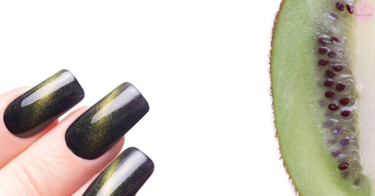 a close-up of a hand showing dark shimmery nail polish with gold flecks paired beside a sliced cucumber with seeds.