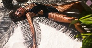a person lying on a tanning bed with leaf-patterned design showing skin before sunless tanning results.