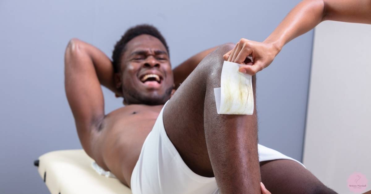 a person experiencing discomfort while attempting homemade bikini line hair removal using duct tape as a wax strip substitute