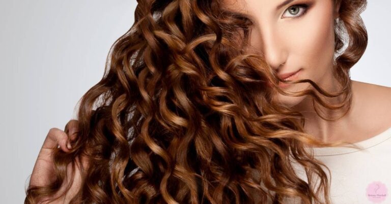 a woman showcasing voluminous, well-defined curly hair for a hydrating, defrizzing shampoo guide