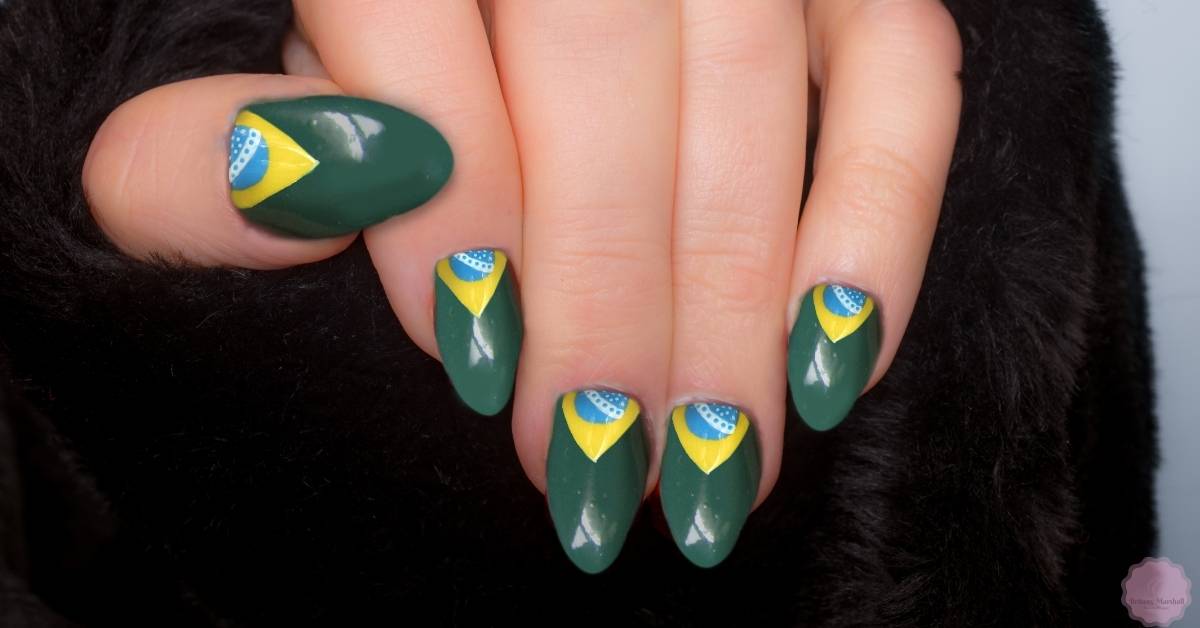 a close-up of a manicure showcasing dip powder nails in green with Brazilian flag-inspired designs