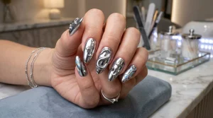 Futuristic aespa nail designs featuring liquid chrome 3D metallic ribbons and silver starbursts